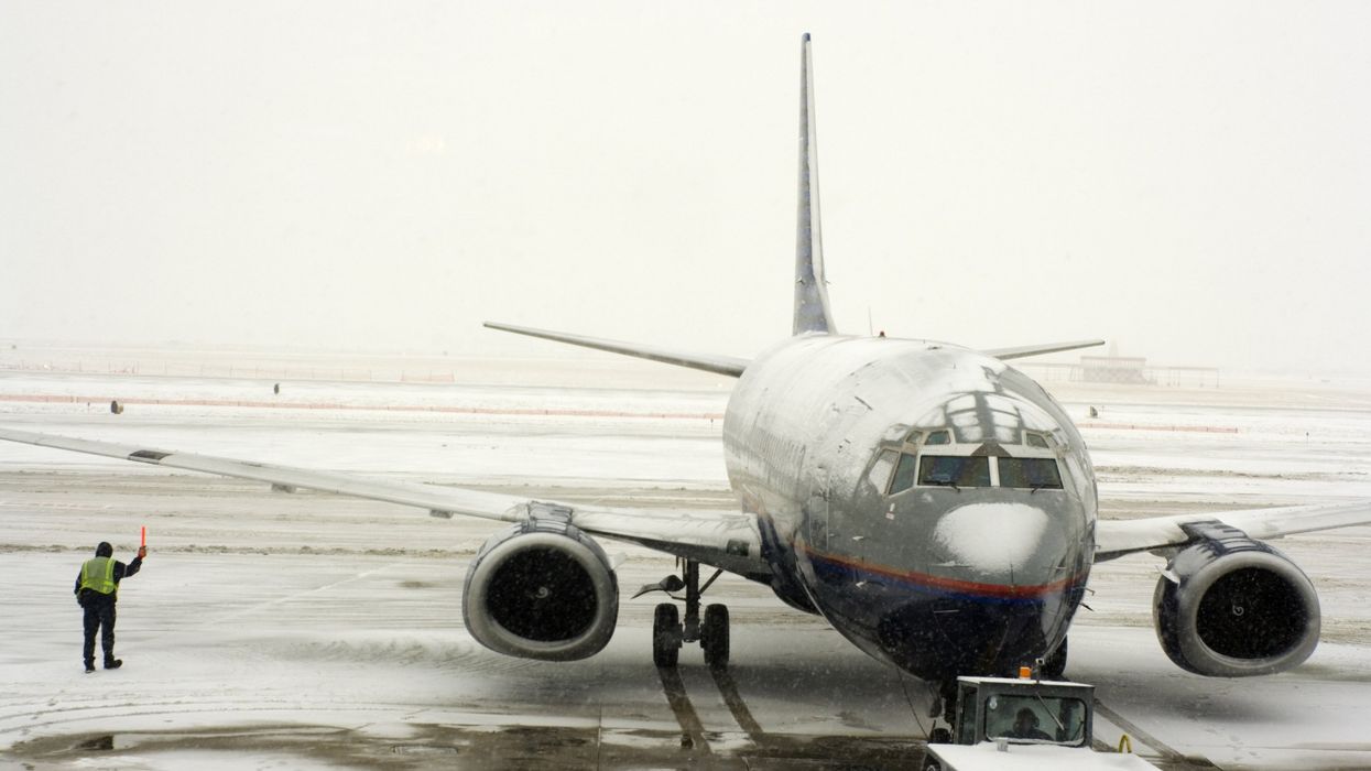 Airplane on runway covered in snow (illustrative).