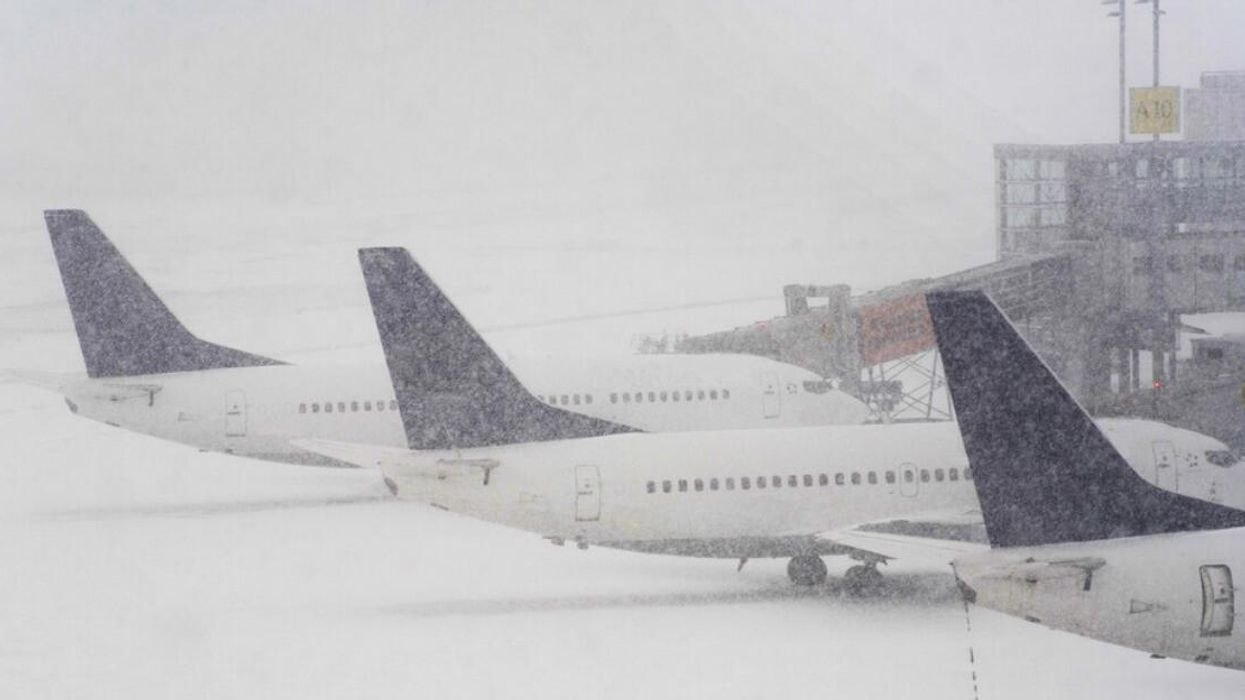 Airplanes parked in the snow.