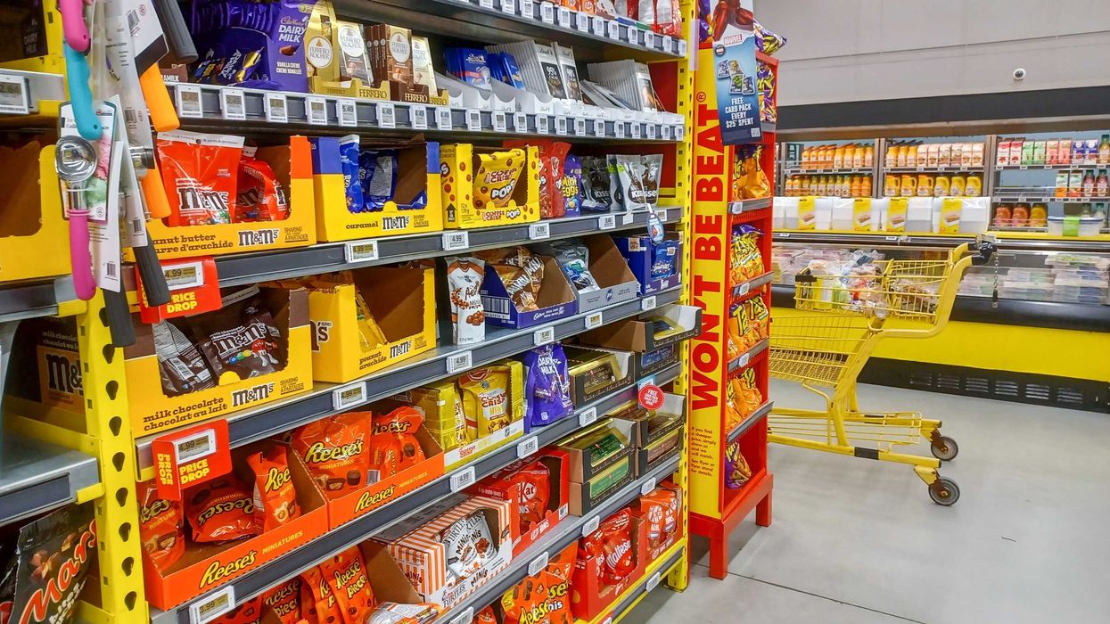 aisle with a shopping cart in a no frills store