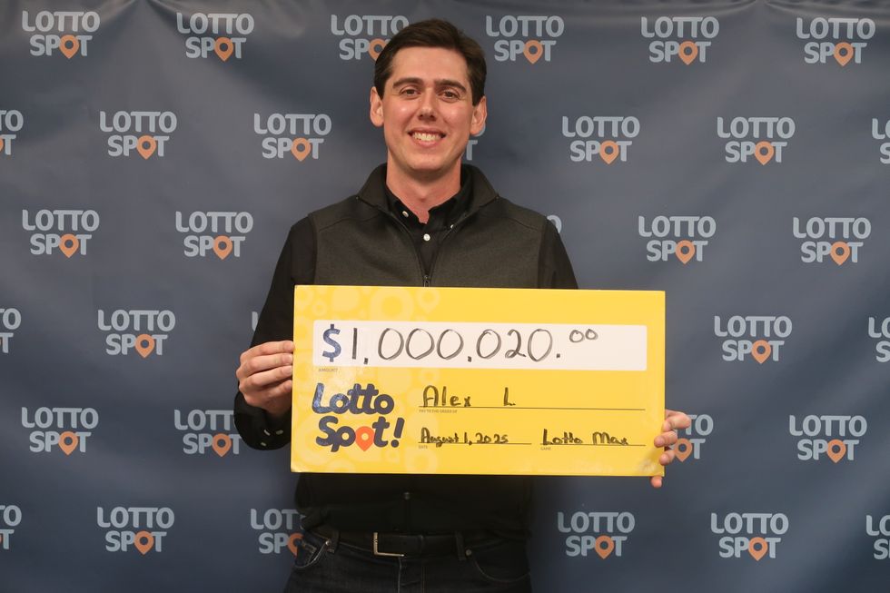 alex larson holding a $1 million lotto max cheque