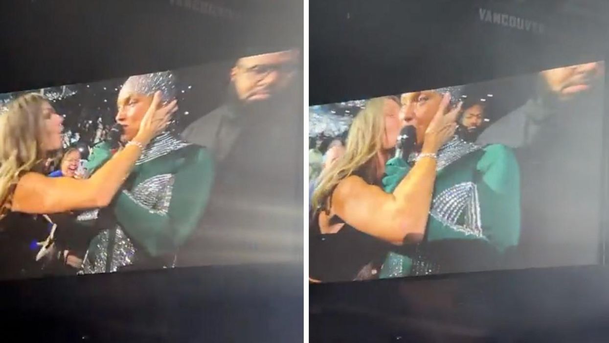 Alicia Keys being kissed by a fan.