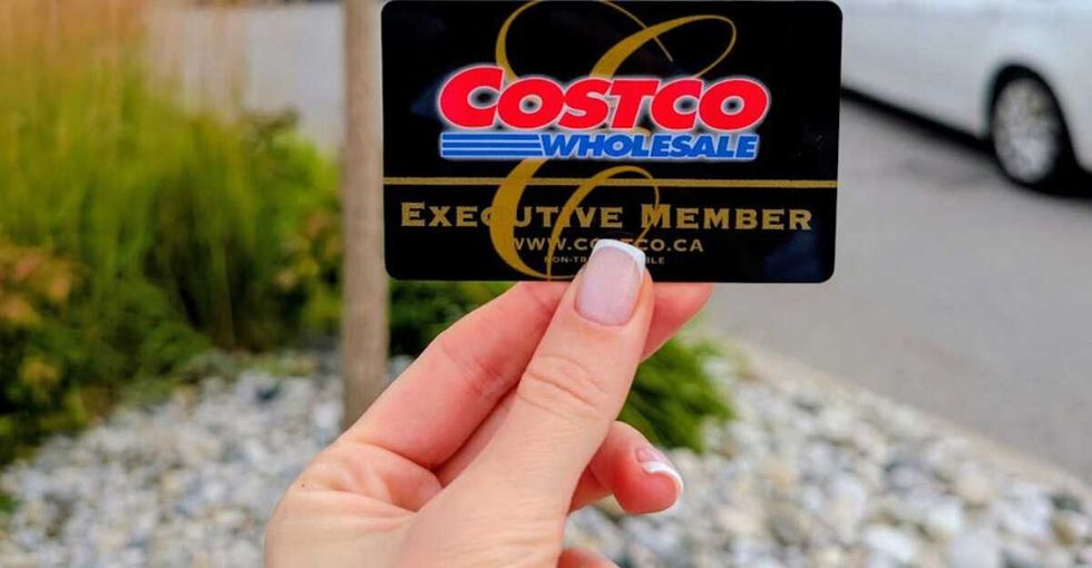Alona holding a Costco Executive member card outdoors.