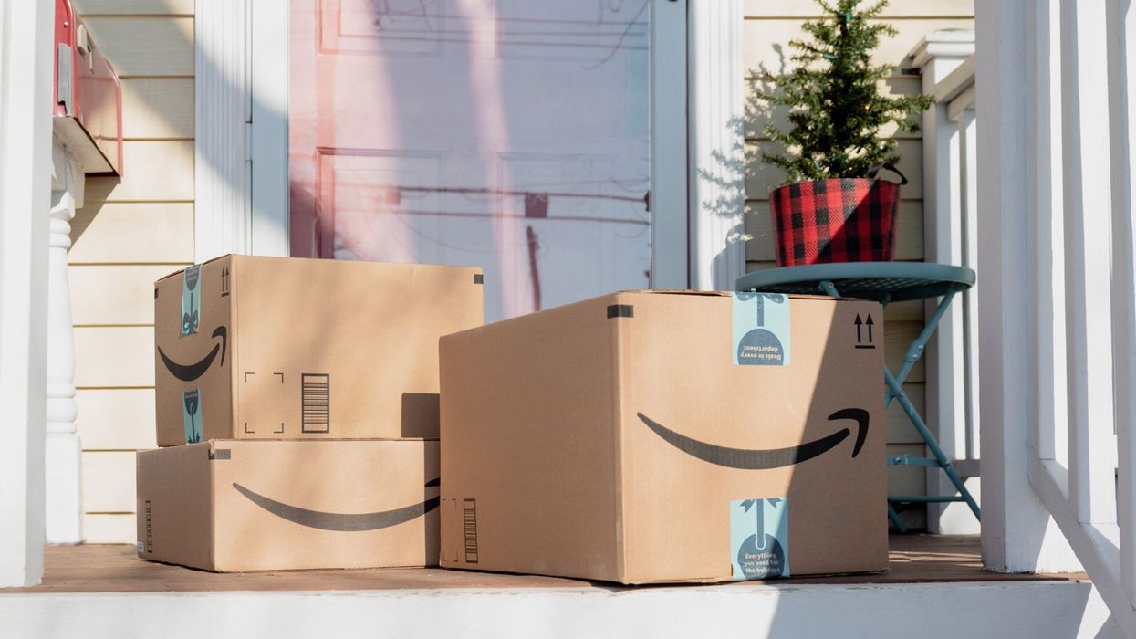 Amazon packages on the porch of a house.