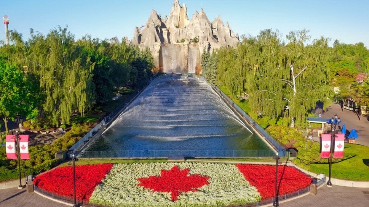 An aerial view of a theme park with a mountain and Canadian flag-themed garden.