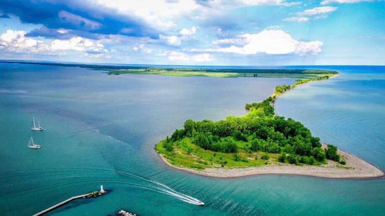 An aerial view of land surrounded by blue water.