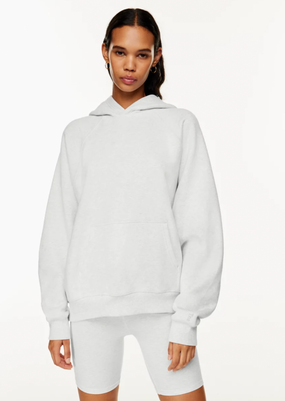 An Aritzia model wearing the Cozy Fleece Mega Raglan Hoodie.