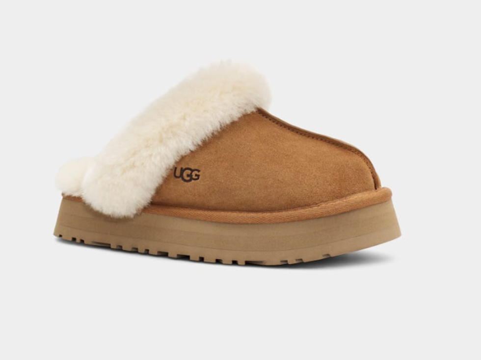 An brown and white UGG slipper.
