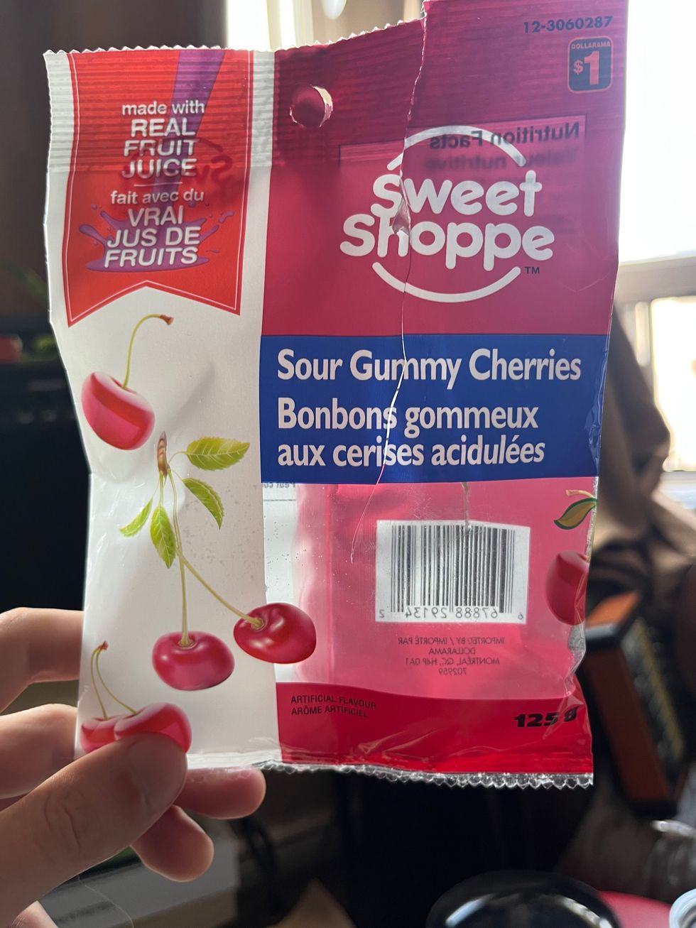 An empty package of Sour Gummy Cherries.