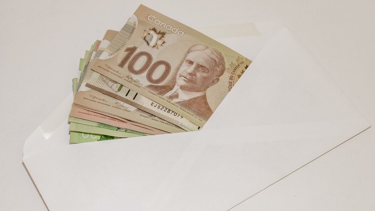An envelope full of Canadian bills (illustrative).