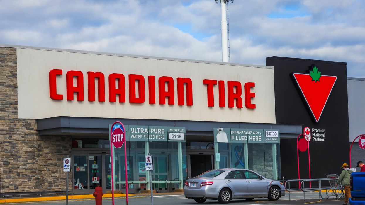 An exterior shot of a Canadian Tire store with a car parked outside.
