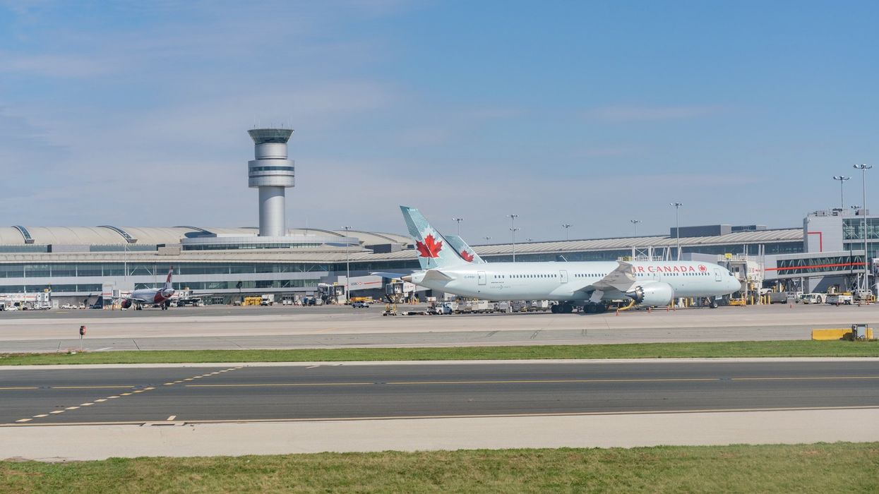 An exterior view of the Toronto Pearson International Airport with an Air Canada airplane.