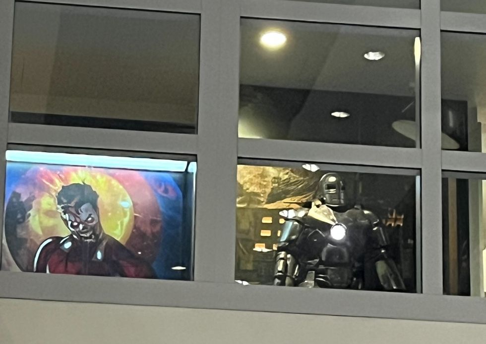 An image of zombie Iron Man and a mannequin of Iron Man's MK I armour as seen through a window at Marvel Studios.