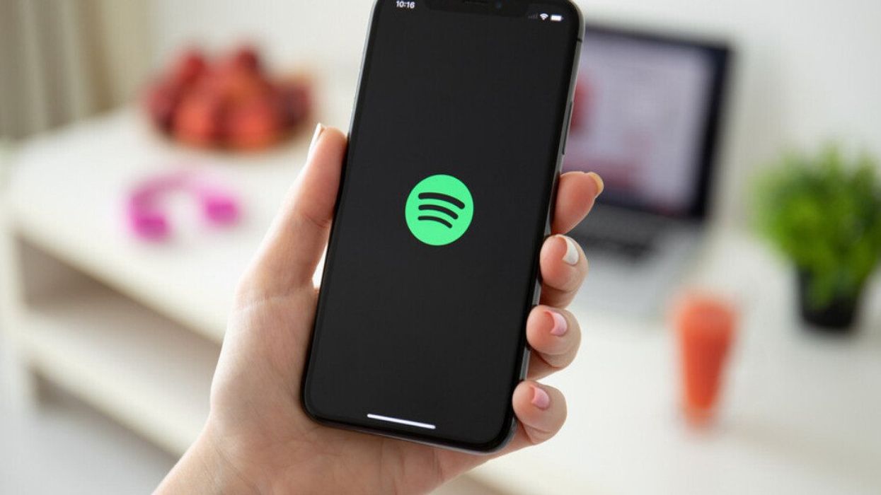 An iPhone showing Spotify on the screen.