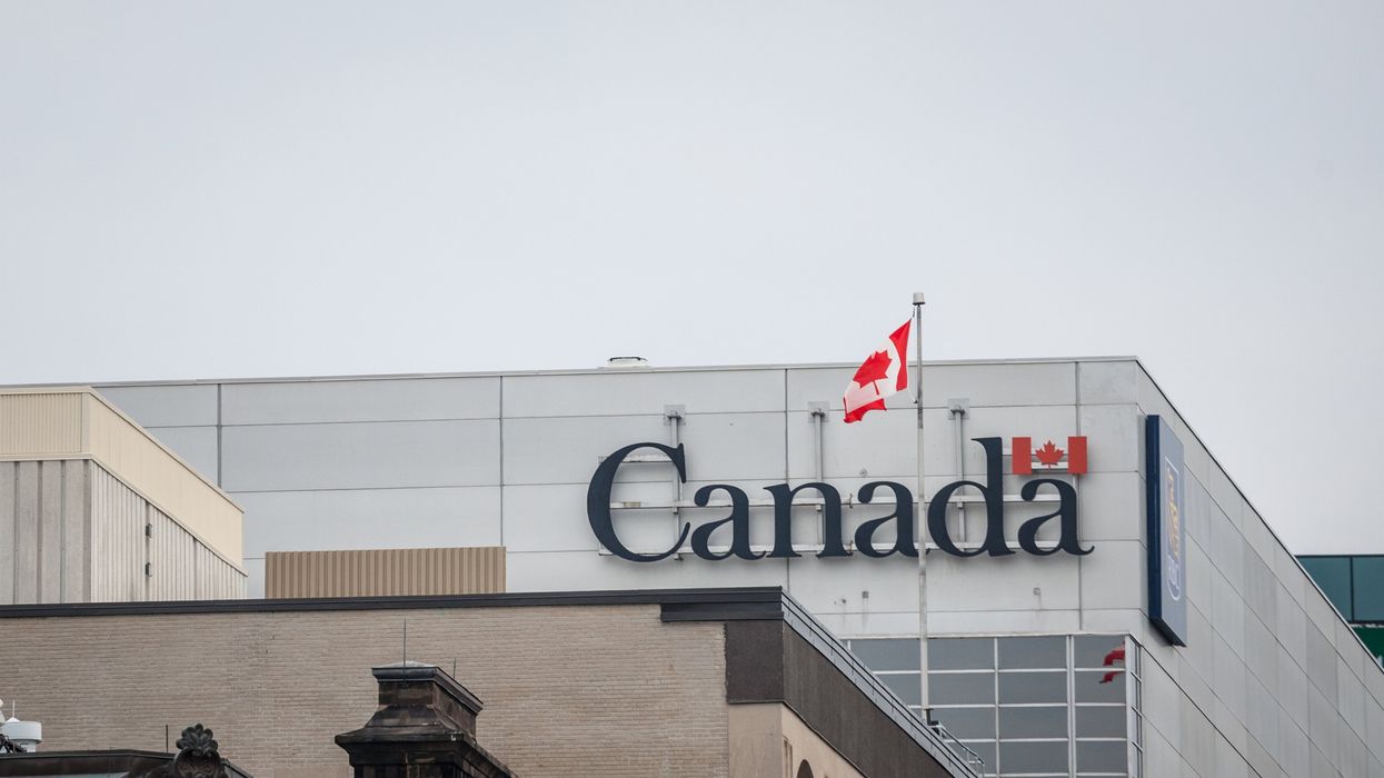An office building with a sign reading "Canada" and a Canadian flag.