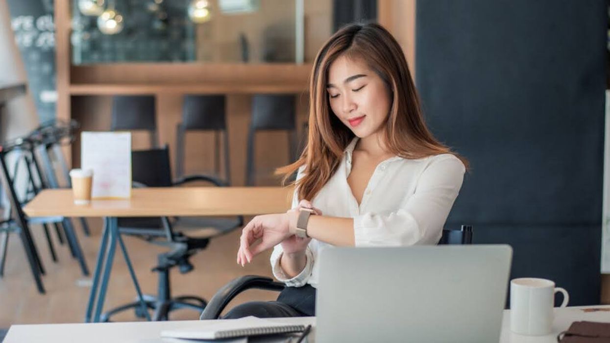 An office worker checks their watch.