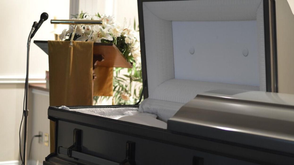 An open casket inside a funeral home.