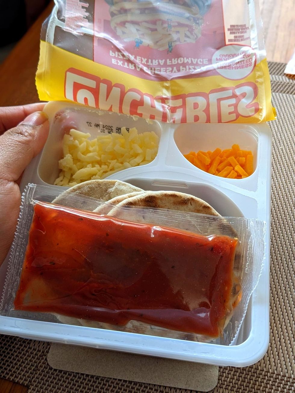 An open package of Lunchables Cheese Pizza.