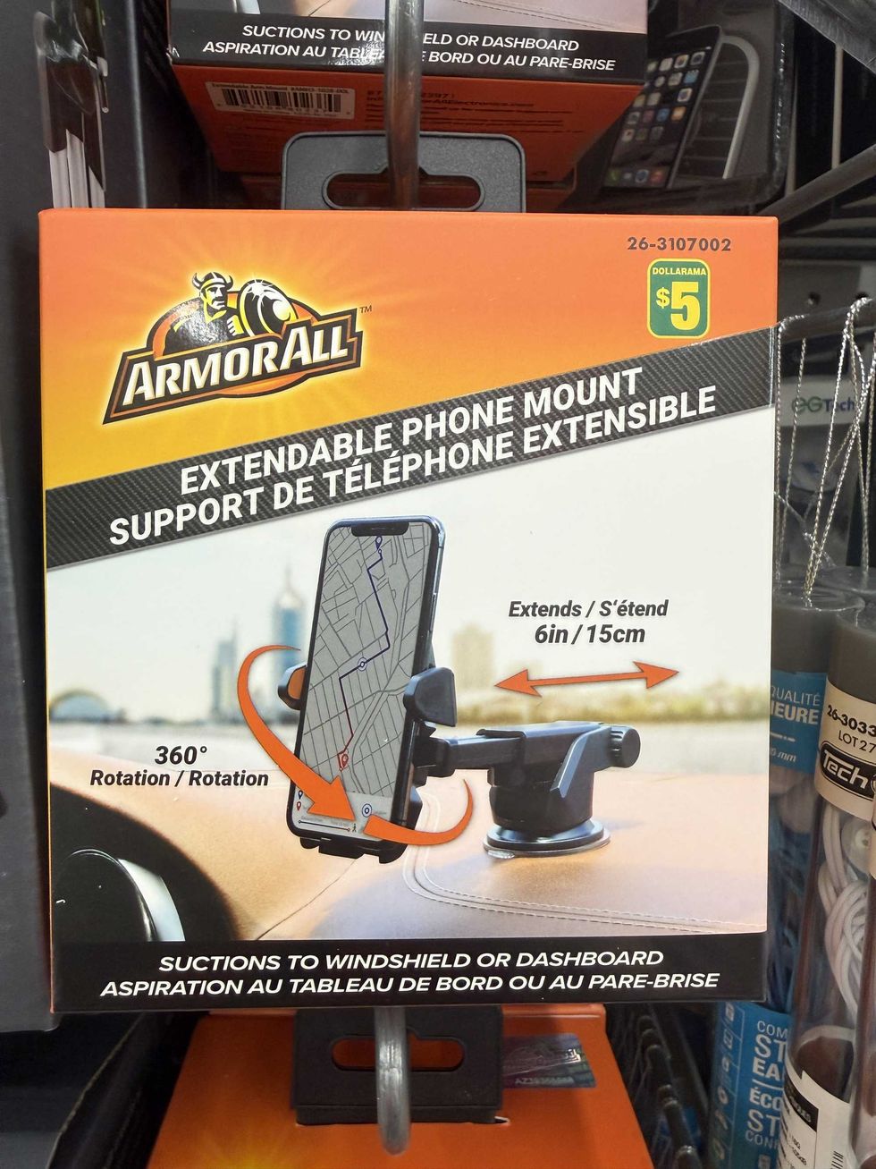 An orange and black box with a picture of a phone sitting inside a phone mount on a car dashboard.
