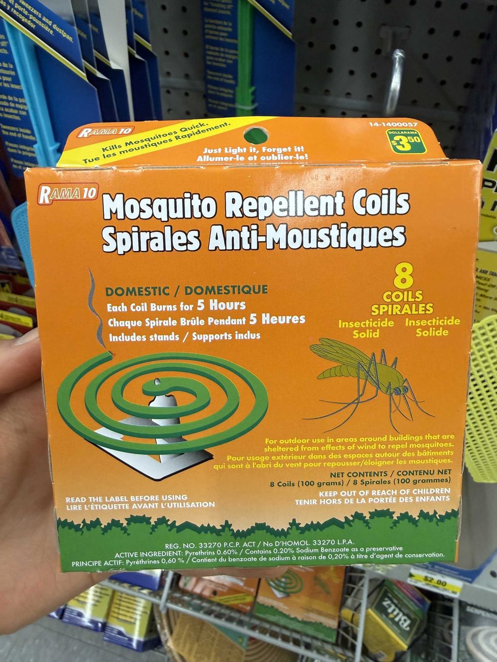 An orange box with a green coil on it and a picture of a mosquito and a label reading mosquito repellent coils.