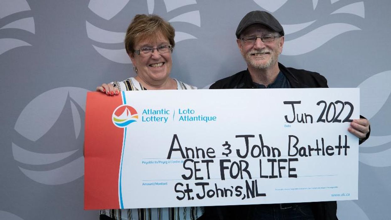 Anne and John Bartlett holding a Set for Life cheque.