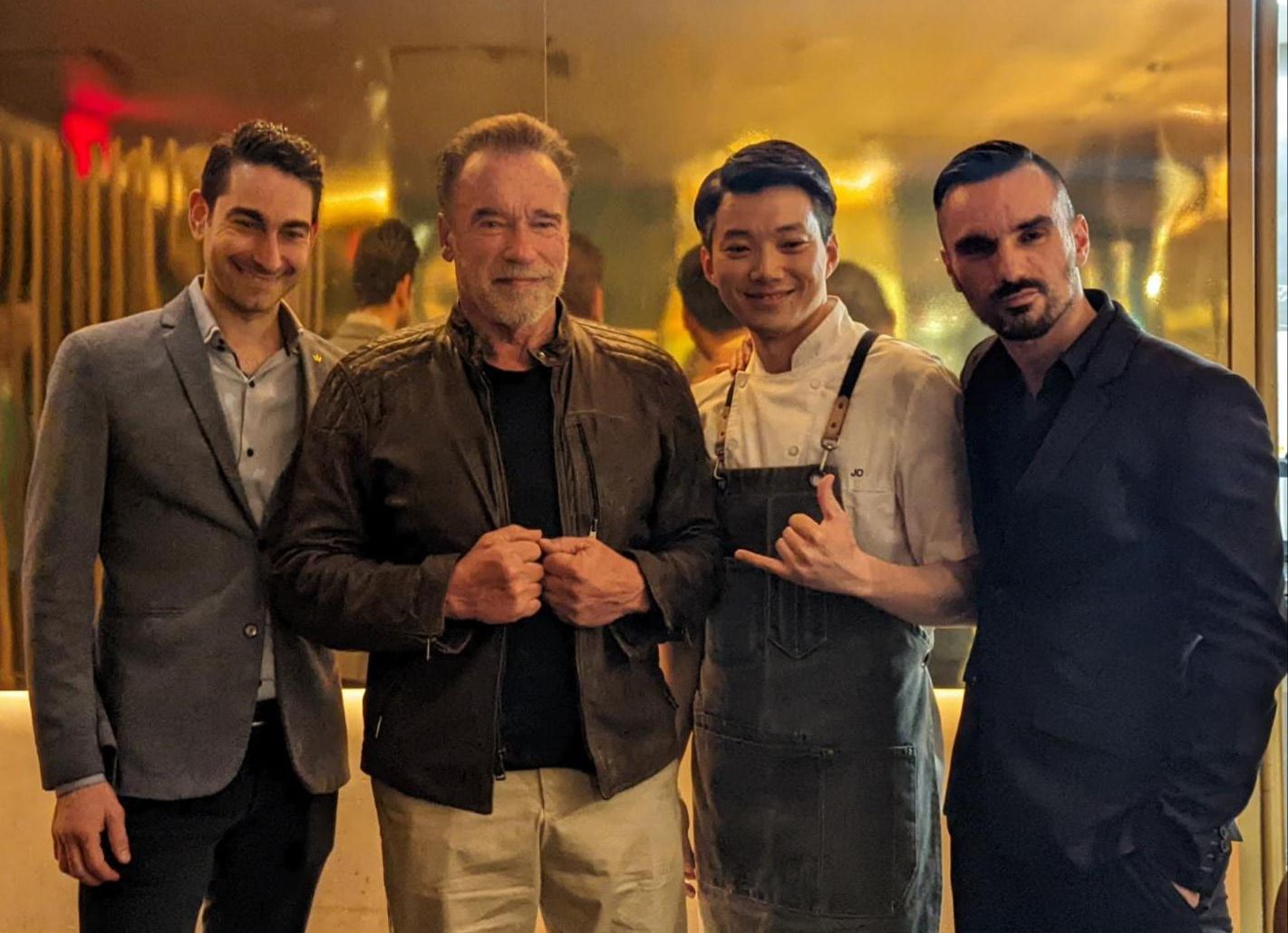 Arnold Schwarzenegger with Akira Back restaurant staff.