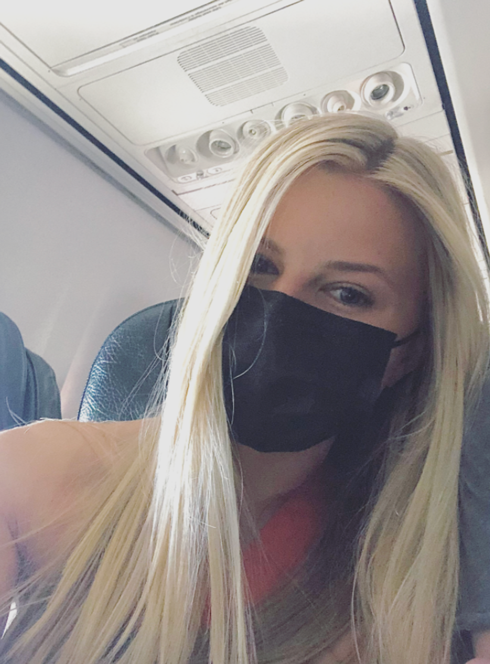 Ashley Harris taking a selfie on a plane