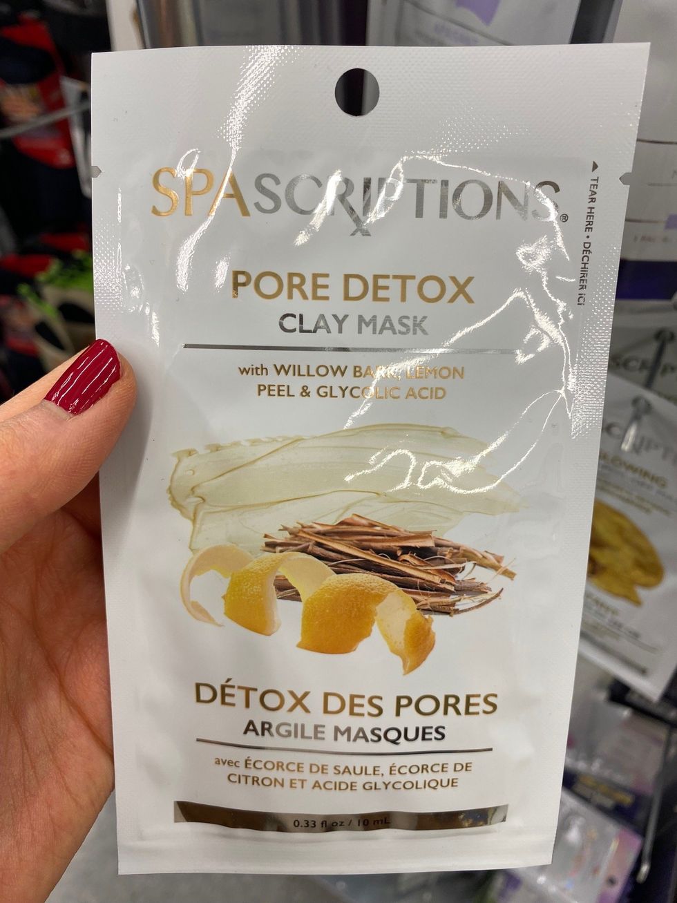 Asymina holding a face mask at Dollarama.