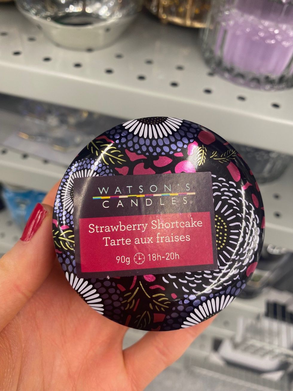 Asymina holding a multi-coloured candle at Dollarama