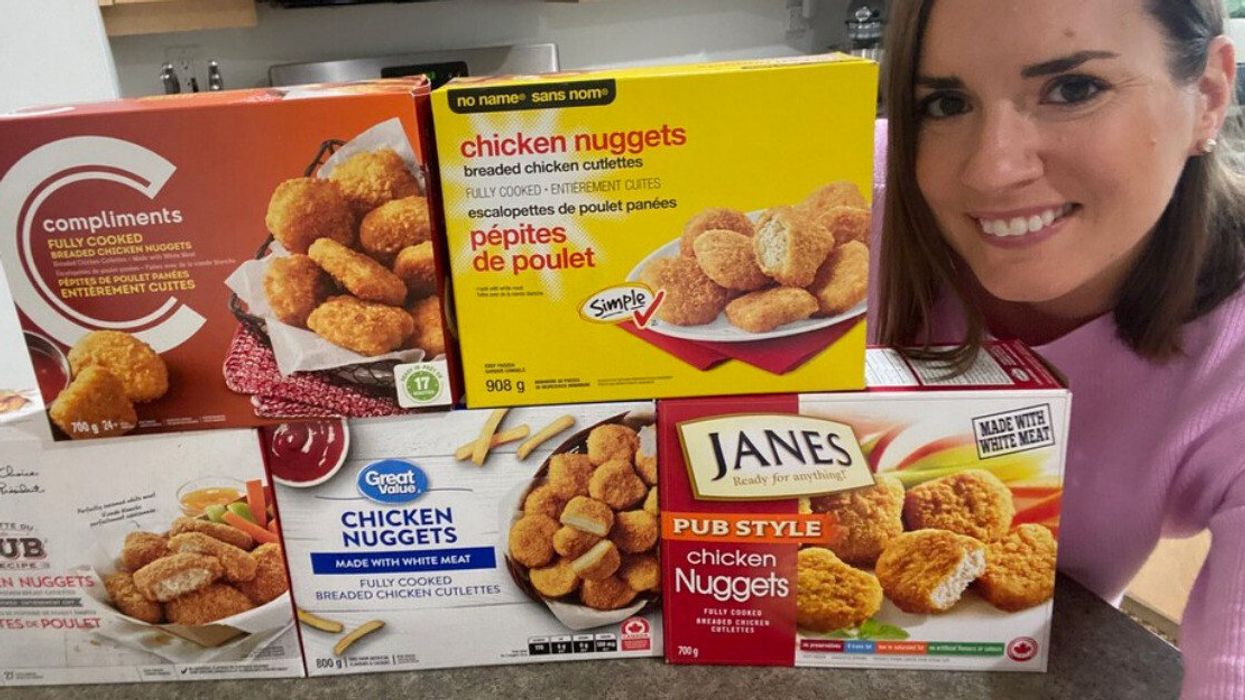 Asymina next to five boxes of chicken nuggets.