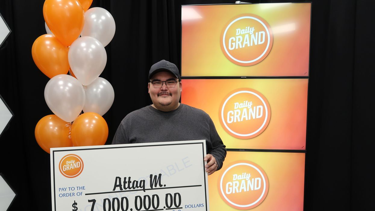 Attaq Makpah holds his cheque.