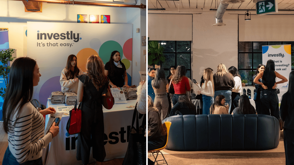 Attendees visiting the Investly booth at an event focused on investing and financial education.