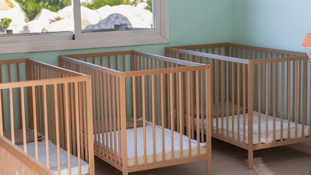 Baby cribs in a room.