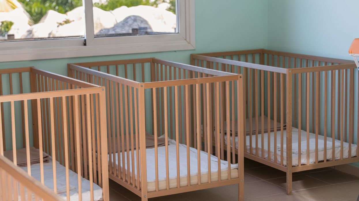 Baby cribs in a room.