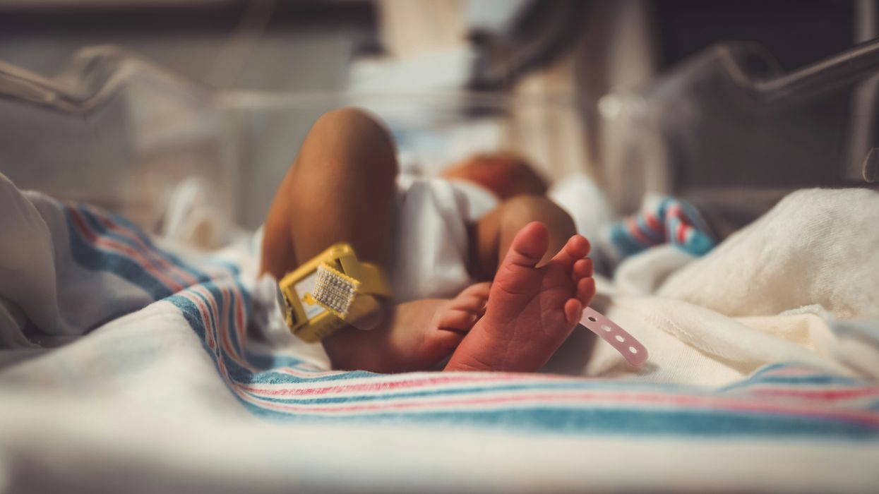 baby lying on a blanket in a hospital