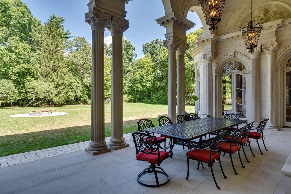 Backyard patio with fancy columns.