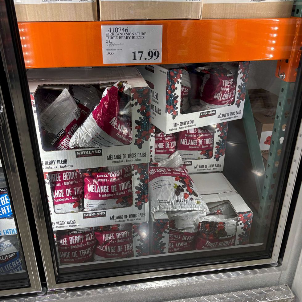 bags of kirkland signature frozen berry blend in a freezer at costco