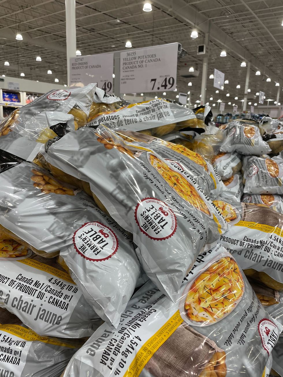 bags of potatoes stacked in a costco warehouse's grocery section