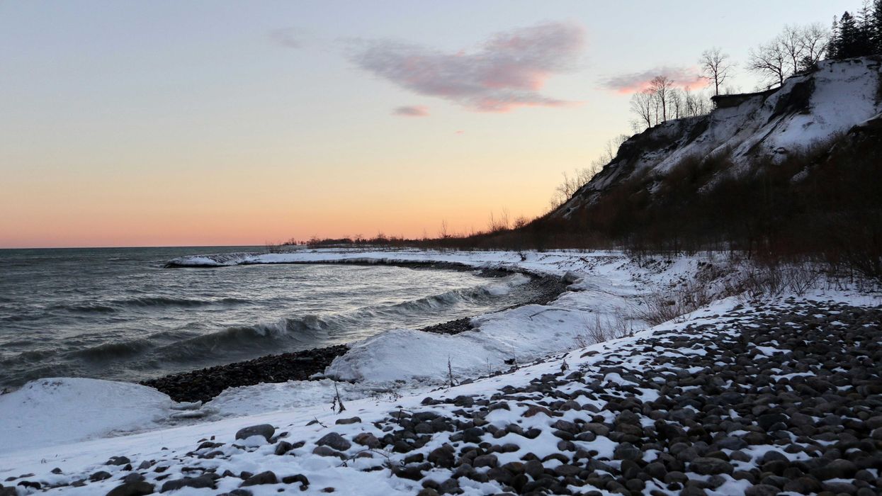 beach in ontario covered in snow at sunset