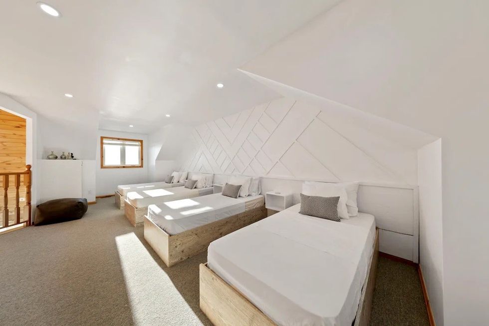 Bedroom with four beds.