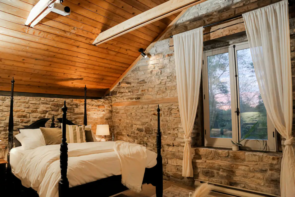 Bedroom with stone walls.