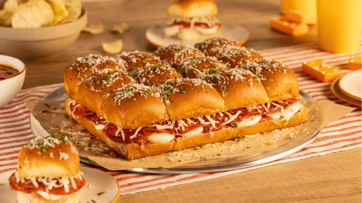 Big game pizza sliders by King's Hawaiian on a serving board.