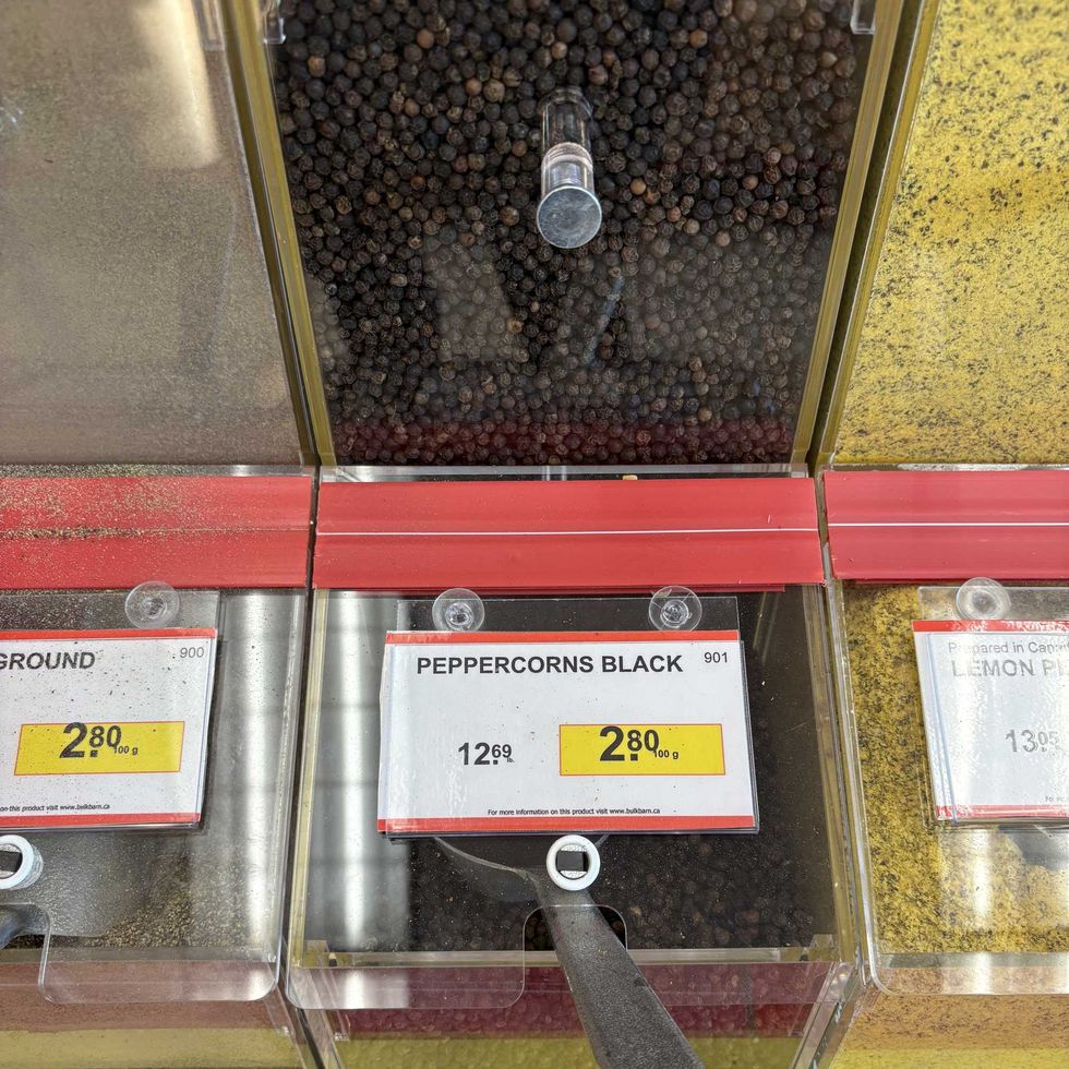 bin of whole Black peppercorns at Bulk Barn