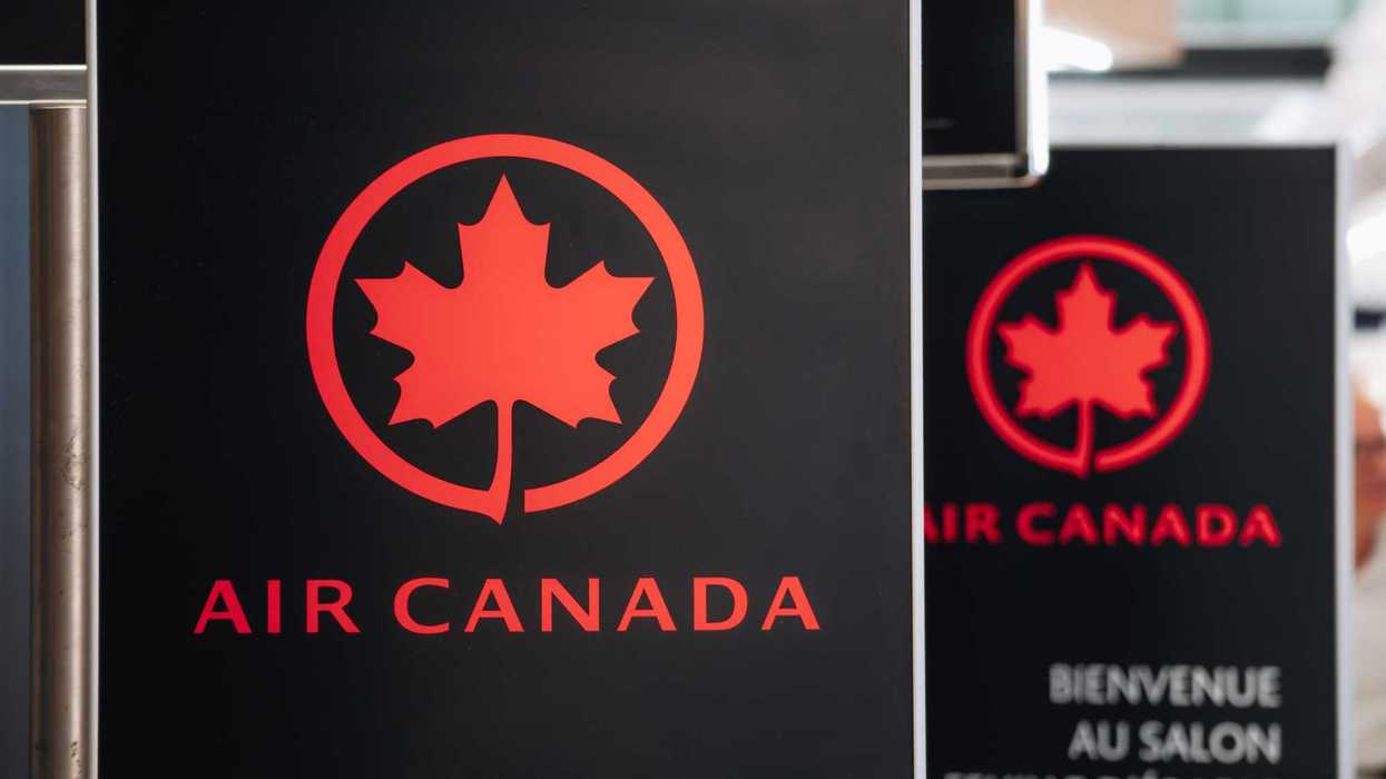 black and red air canada sign at a canadian airport