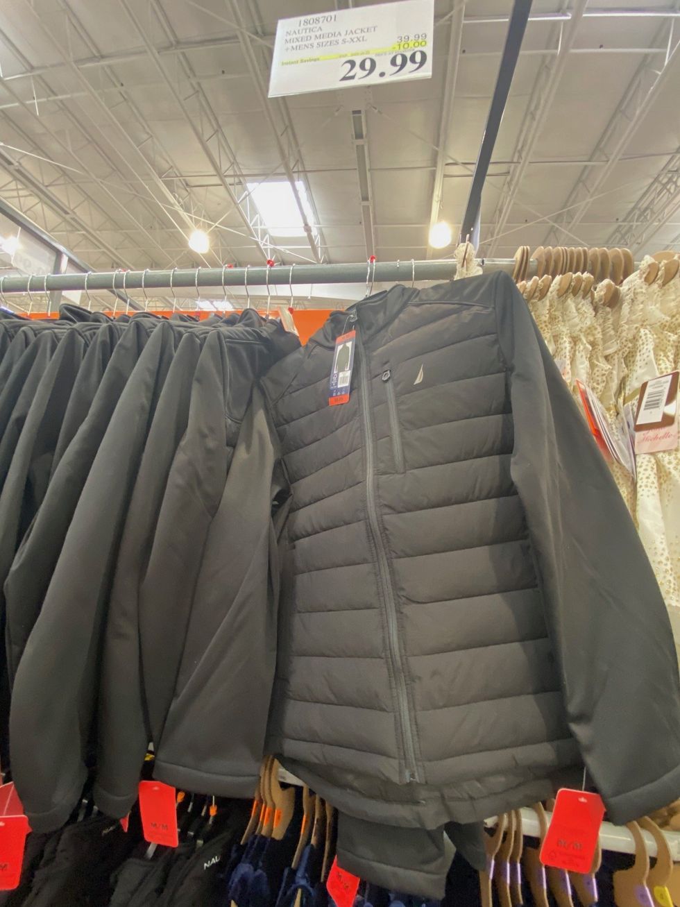 Black jackets hanging on display at Costco.