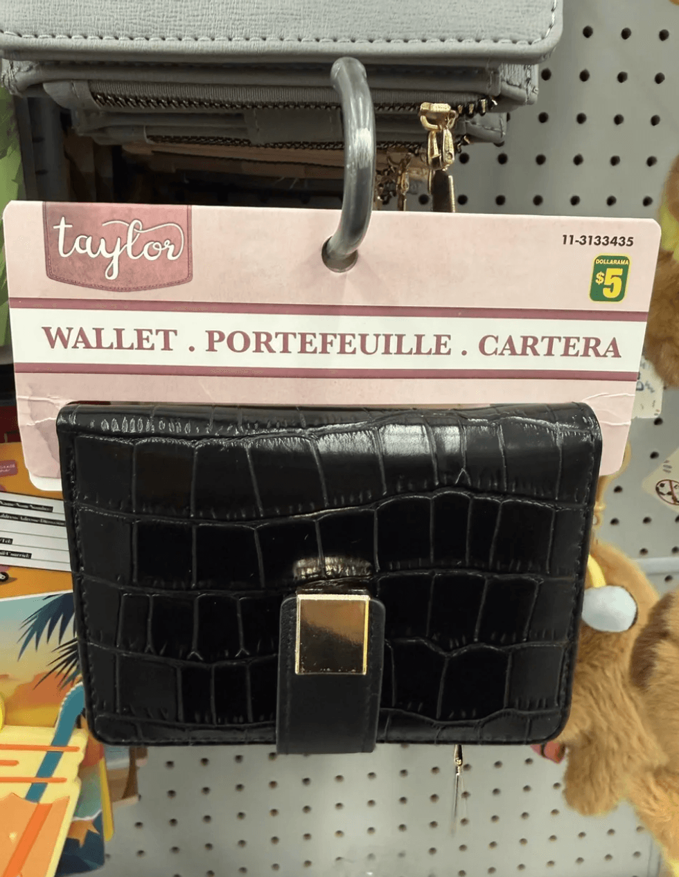 Black textured wallet with gold clasp on display, priced at $5.