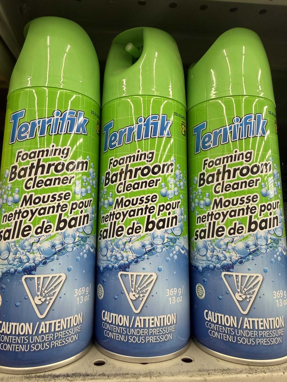 Blue and green canisters that say Terrifik foaming bathroom cleaner.
