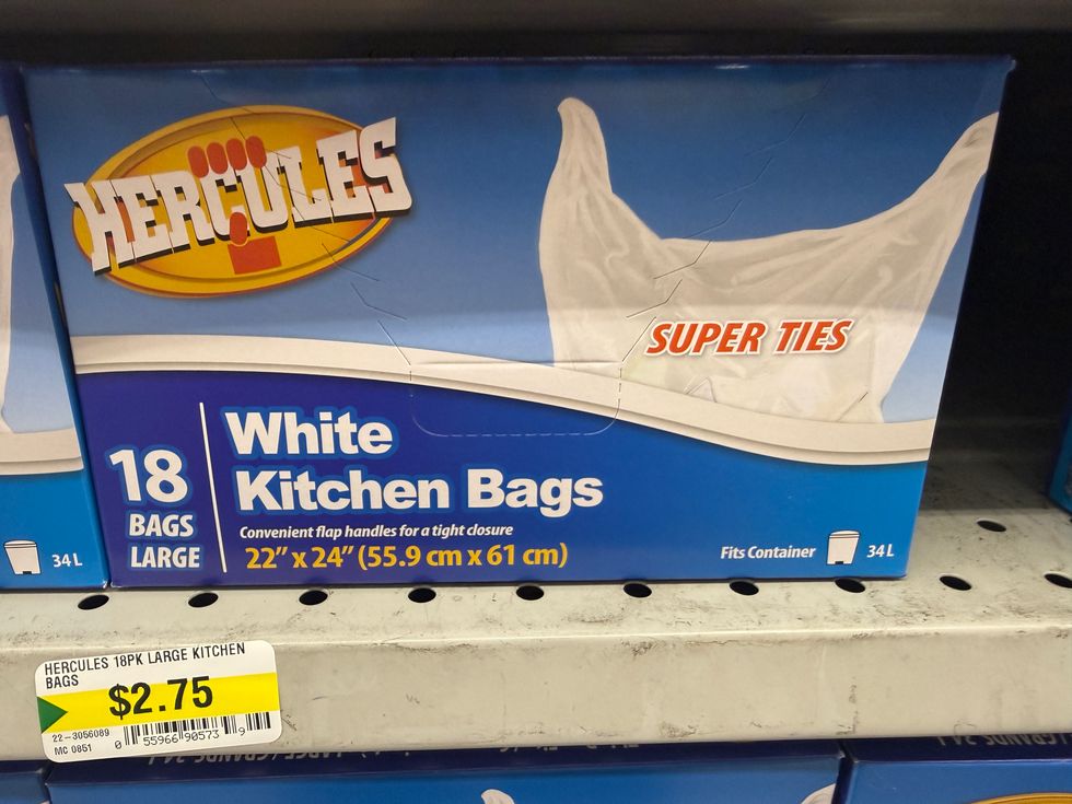 Blue and white box on a store shelf that says Hercules white kitchen bags on the front.