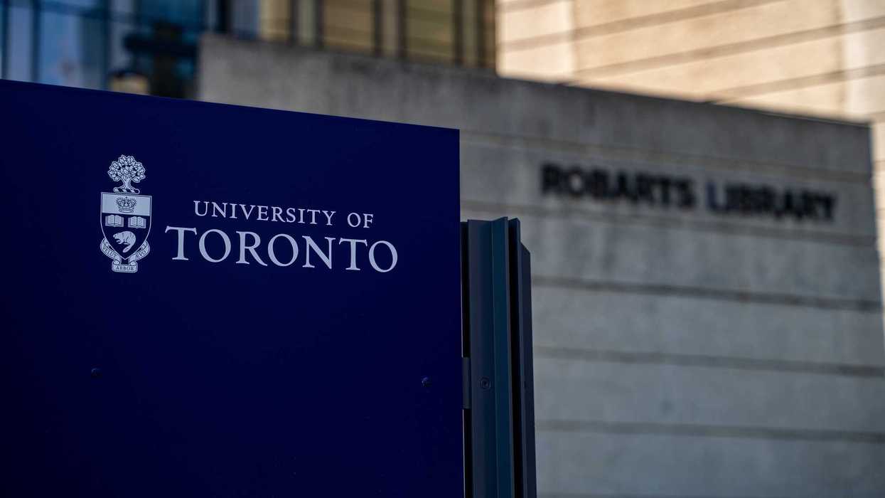 blue and white university of toronto sign in front of building