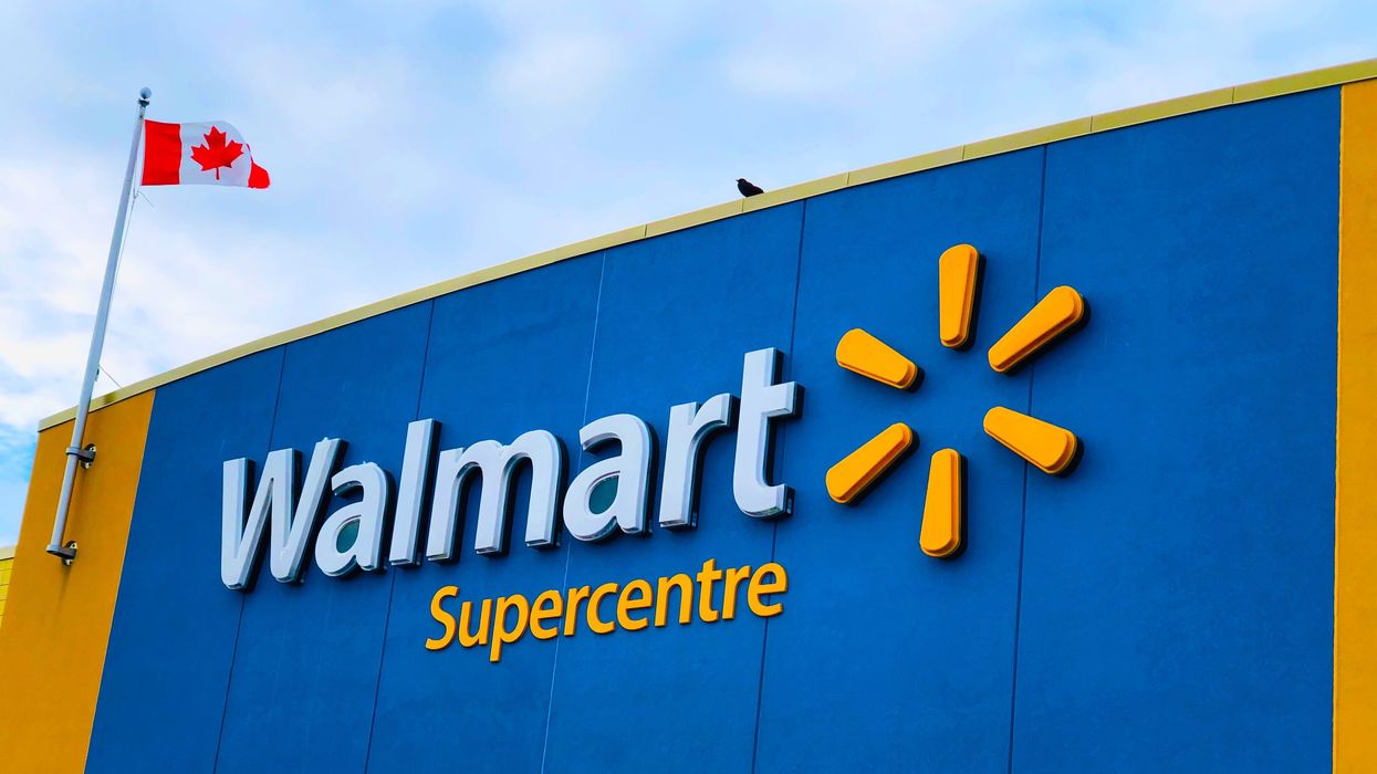 blue and yellow walmart supercentre storefront sign with a canadian flag