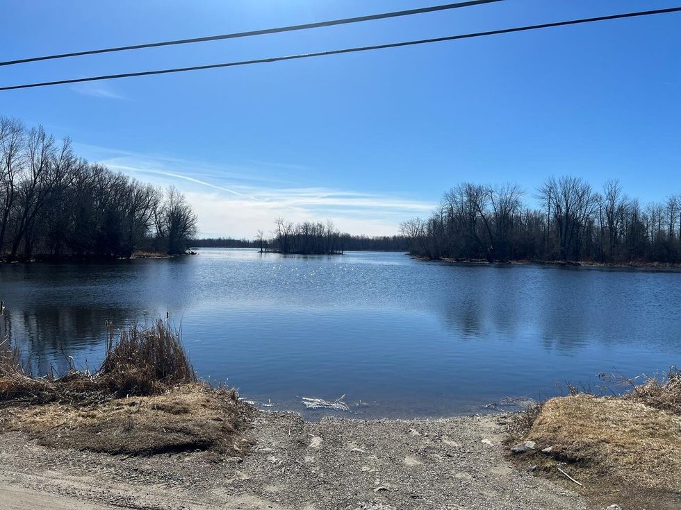 Blue water with trees.